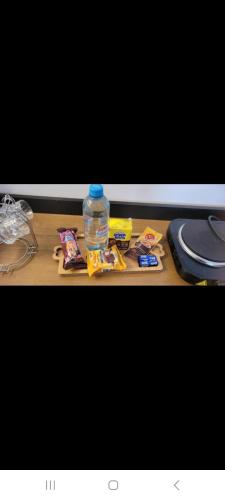 a bottle of water sitting on top of a table at Flat in Rio Verde