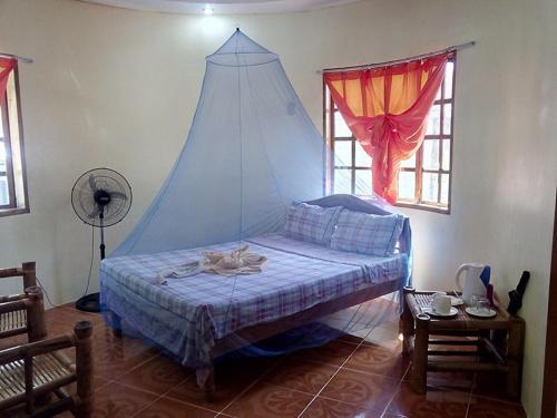 a bedroom with a bed with a tent on it at Old Castle in Anda