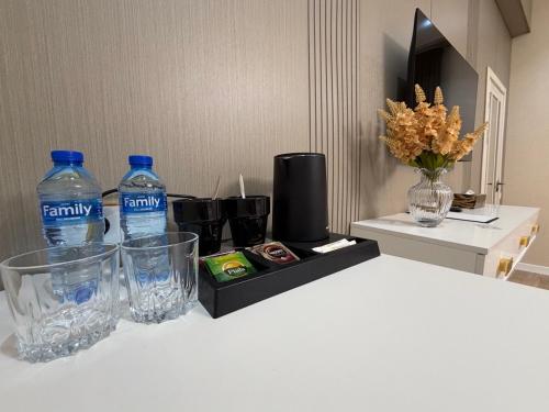 a table with two bottles of water and a black box at ART REGENCY Premium Hotel in Tashkent