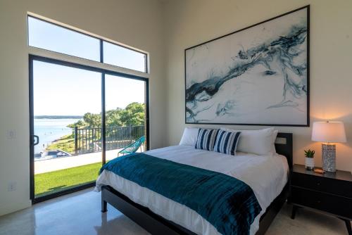 a bedroom with a bed and a large window at Happy Owl Lakehouse in Canyon Lake