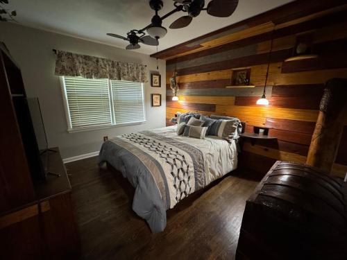 a bedroom with a bed and a wooden wall at Super Comfy 3 BR Home Sleeps 8 in Doraville