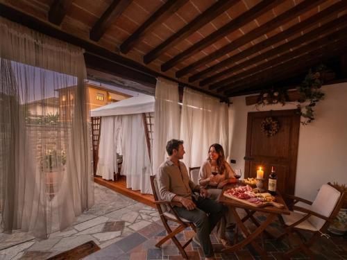a man and a woman sitting at a table at La Suite Toscana in Certaldo