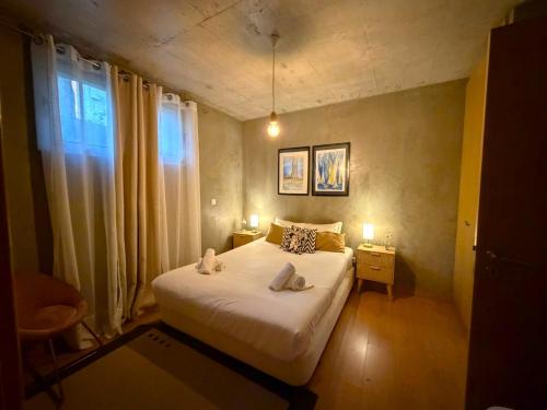 a bedroom with a bed with two towels on it at Porto Santo Balcony View House in Porto Santo