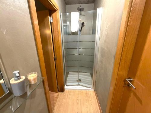 a shower with a glass door in a bathroom at Porto Santo Balcony View House in Porto Santo