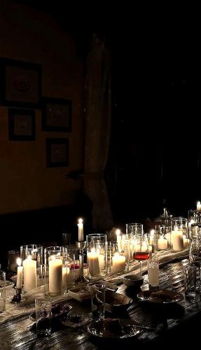 a table with candles and wine glasses on it at Hush Cappadocia Hotel in Ürgüp