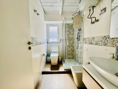 a bathroom with a toilet and a sink and a shower at Luxury Allegra’s home in Syracuse