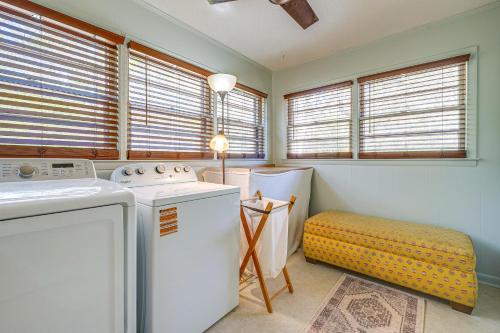 a laundry room with a washer and dryer and windows at Deck & Spacious Yard! Wilmington Gem on Half-Acre in Wilmington