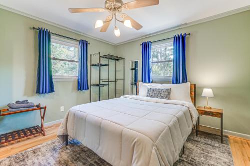 a bedroom with a bed and a ceiling fan at Deck & Spacious Yard! Wilmington Gem on Half-Acre in Wilmington