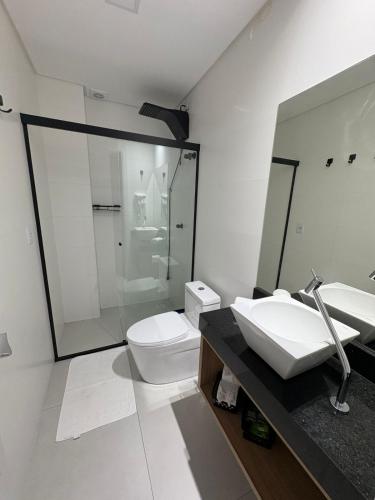 a bathroom with a sink and a toilet at Apartamento Dein Haus in Pomerode