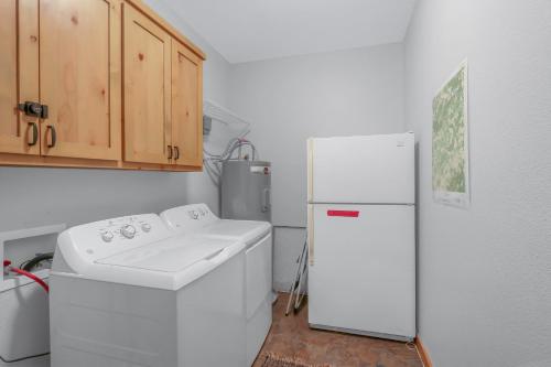 a kitchen with a refrigerator and a washing machine at Fairlawn on the Blanco in Wimberley