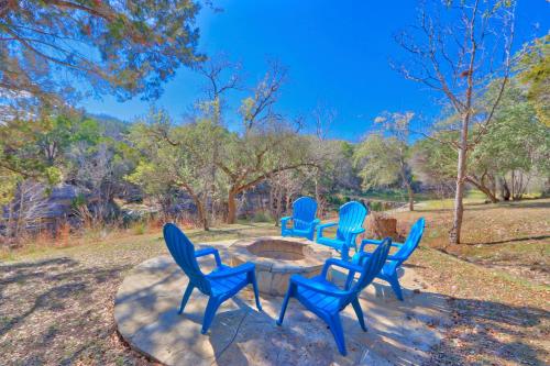 a group of blue chairs sitting around a table at Falls Log Home in Wimberley