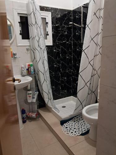 a bathroom with a shower curtain and a toilet at ANDRIA'S luxury family studio near Casino limassol in Limassol