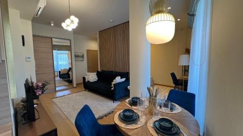 a dining room and living room with a table and chairs at DO Apartments in Druskininkai
