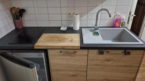 a kitchen with a sink and a counter top at Douce Altitudes Cauterets in Cauterets