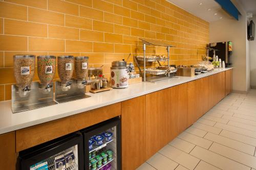 a kitchen with a counter with drinks and food at SpringHill Suites Alexandria in Alexandria