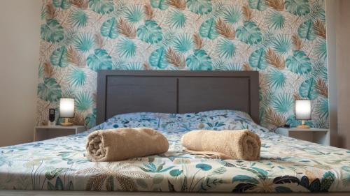 a bedroom with a bed with two towels on it at Les Cannes Trankil in Saint-Louis