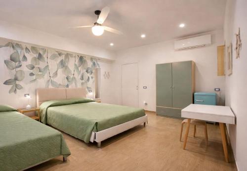 a bedroom with two beds and a ceiling fan at Lungomare 70 in Marzocca di Senigallia