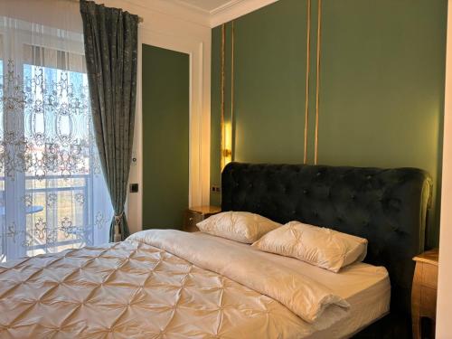 a bed with two pillows on it in a bedroom at Vert Unique Luxury Experience in Băile Felix in Baile Felix