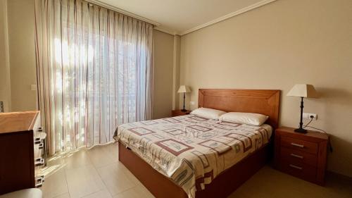 a bedroom with a bed and a large window at 2-bedroom apartment with terrace VistaRoja in Granadilla de Abona