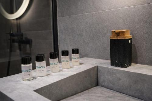 a group of four bottles on a counter in a bathroom at Captivating 2-Bed Apartment in Tunis in Tunis