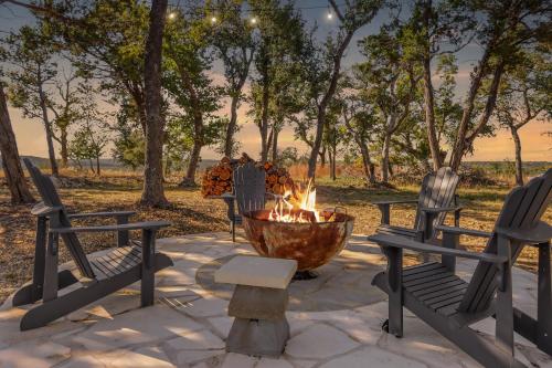 a fire pit with two chairs and a fire hydrant at Daybreak Ridge Sunrise Bluff in Blanco
