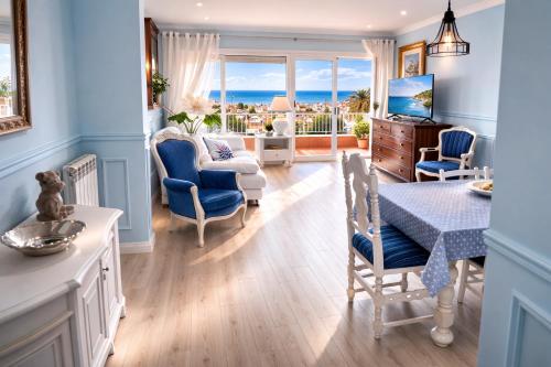 a living room with a table and chairs and the ocean at Due Passi dal Cielo Apartment Piscina Condominiale fino al 30 Agosto in Anzio