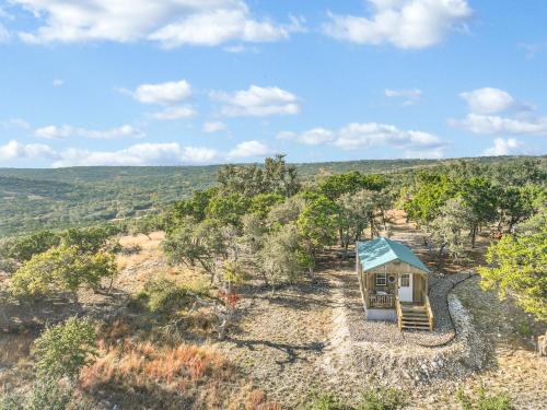 a tiny house sitting on top of a hill at Daybreak Ridge Sunrise Bluff in Blanco