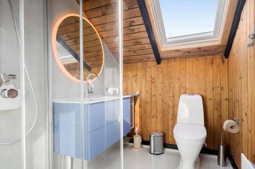 a bathroom with a toilet and a glass shower at 2614-Romo-Stormengevej-18 in Høm