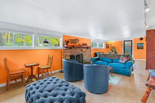 a living room with blue couches and a fireplace at Cypress Moon in Wimberley