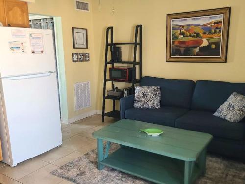 a living room with a blue couch and a table at Super Cute With Deeded Beach Access (#26) - Sleeps 5 in Gulf Shores