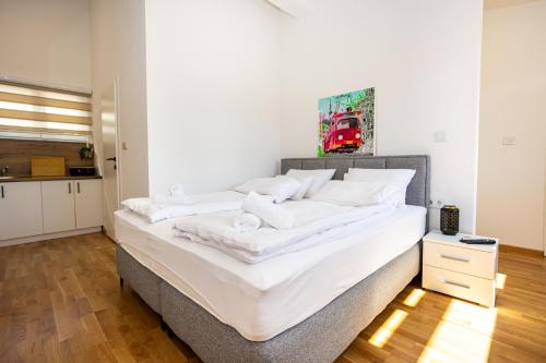 a bedroom with a large bed with white sheets at Sarajevo Boutique Studios in Sarajevo