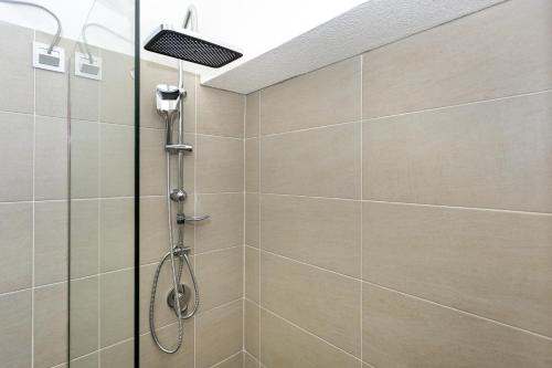 a shower with a glass door in a bathroom at Sarajevo Boutique Studios in Sarajevo