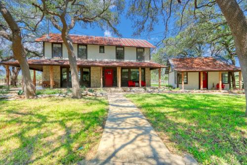 an old house with a red roof and trees at D2 Farms in Wimberley
