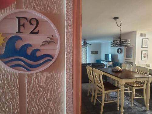 a dining room and kitchen with a table and chairs at The Beach is Only Steps Away (F2) BEACHFRONT - Sleeps 8 in Gulf Shores