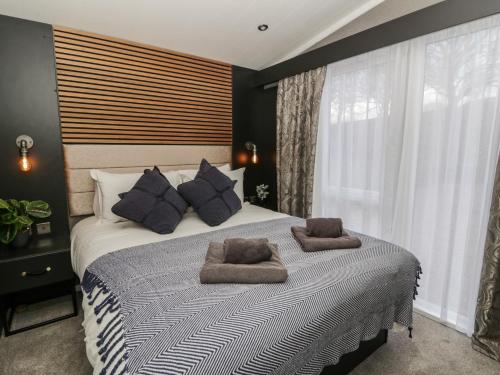 a bedroom with a large bed with two towels on it at Dawn's Rest in Rhayader