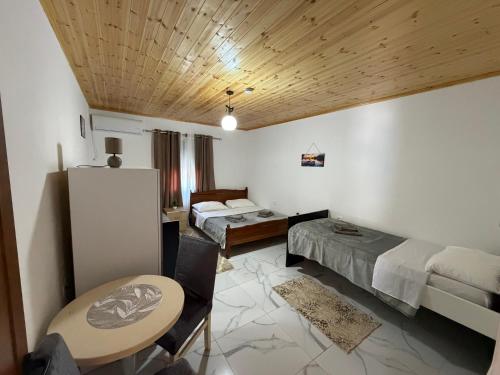 a bedroom with a bed and a table and a table sidx sidx sidx at Xhoen guesthouse in Shkodër