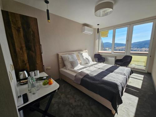 a bedroom with a bed and a table with chairs at Ośrodek Uzdrowiskowy Biawena in Wysowa-Zdrój