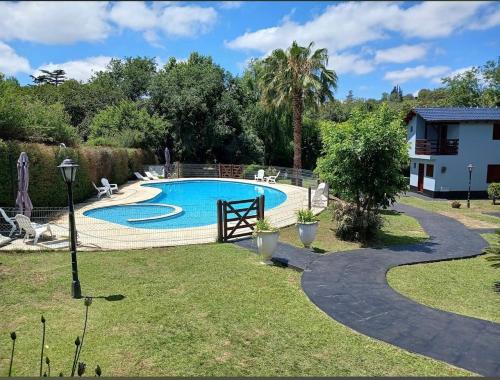 a swimming pool in a yard with a house at Sole Luna in Río Ceballos