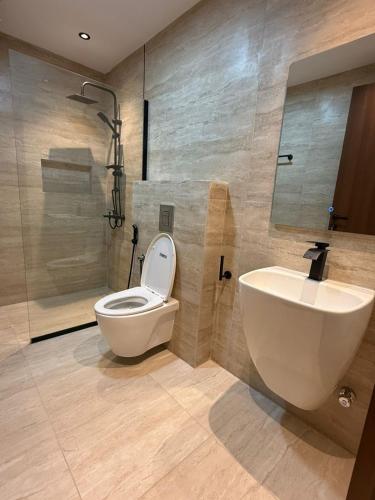 a bathroom with a toilet and a sink and a shower at Modern Studio Near Al Haram And City Center Self Check-in in Medina
