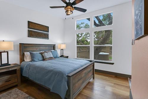 a bedroom with a bed and a ceiling fan at Martha at the Bend in Wimberley