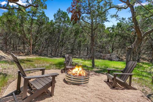 two chairs and a fire pit in a park at Martha at the Bend in Wimberley