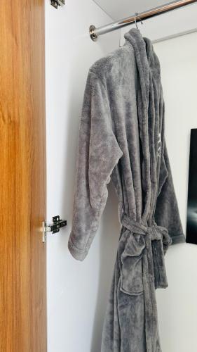 a towel hanging on a wall next to a door at SympaHome in Kiambu