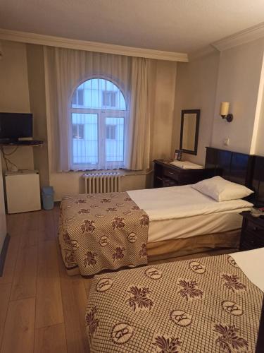 a hotel room with two beds and a window at SPOR HOTEL in Ankara