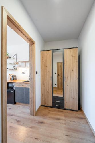 a room with two sliding doors in a kitchen at Studio Arnoštka in Vimperk