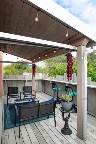 a pergola with chairs and tables on a deck at Heart of Vibrant Railyard-Large Downtown Loft with Prime Location and Beautiful Deck in Santa Fe