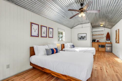 two beds in a room with a ceiling fan at Daybreak Ridge Entire Property in Blanco