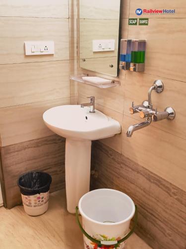 a bathroom with a sink and a toilet at RAILVIEW HOTEL- Nr Platform-1, Railway Station in Bhubaneshwar