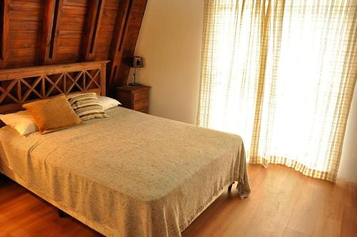a bedroom with a bed and a large window at Cabañas Balboa in Costa del Este