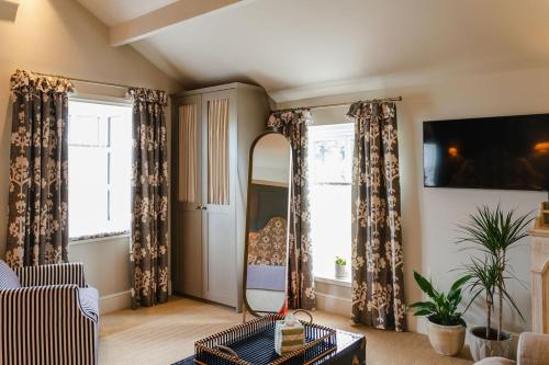 a living room with a couch and a mirror at The 3 Acres Inn & Restaurant in Huddersfield