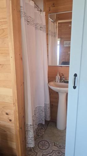a bathroom with a white shower curtain and a sink at Romantic Getaway Peace and a Unique View in Quillota